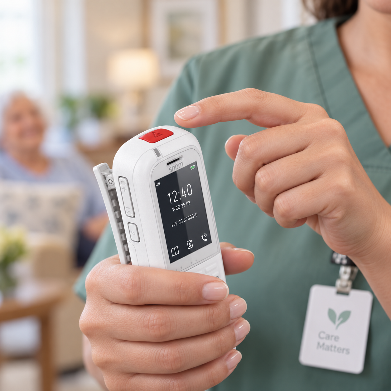 Caregiver holding a Snom DECT handset with a dedicated assistance button